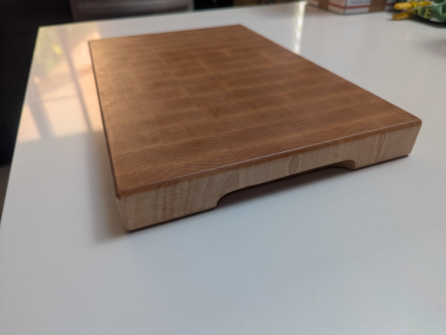 Wooden cutting board on a white surface