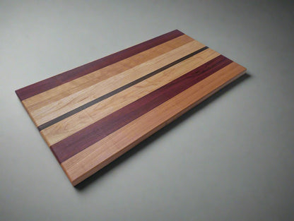 custom made cutting board from walnut, maple, and paduk