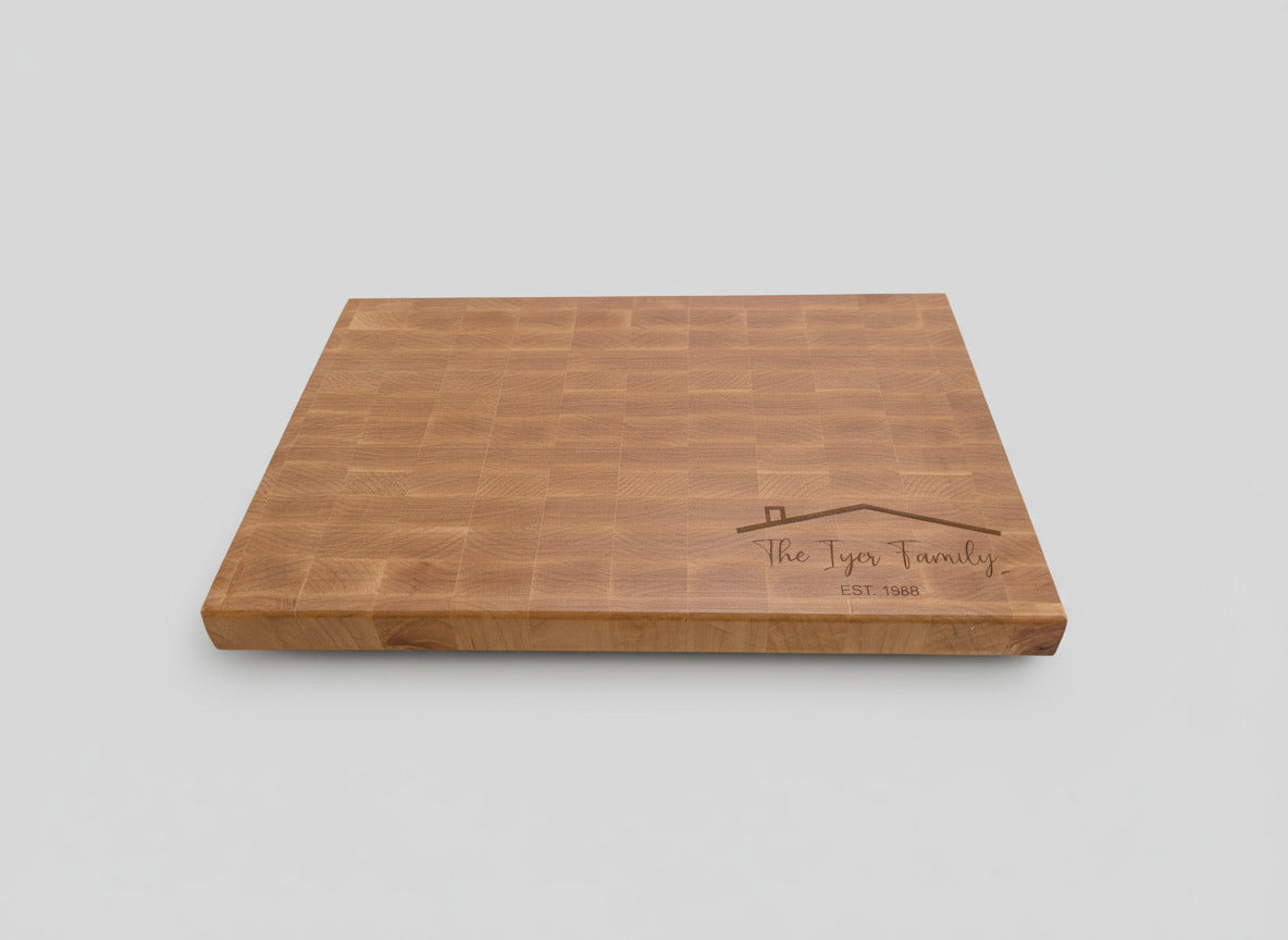 Wooden cutting board with engraved text on a kitchen counter